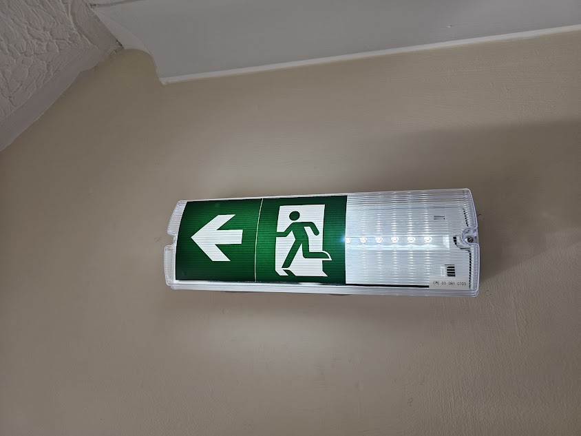 LED emergency exit sign with running-man pictogram fitted by CJA Electrical